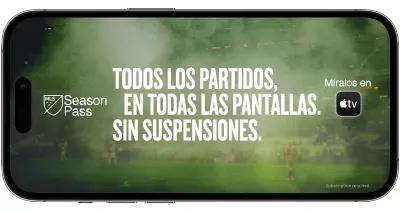 ​​Teléfono con campo de juego verde detrás de la leyenda MLS Season Pass, Watch on Apple TV. Every match. Every screen. No blackouts.​